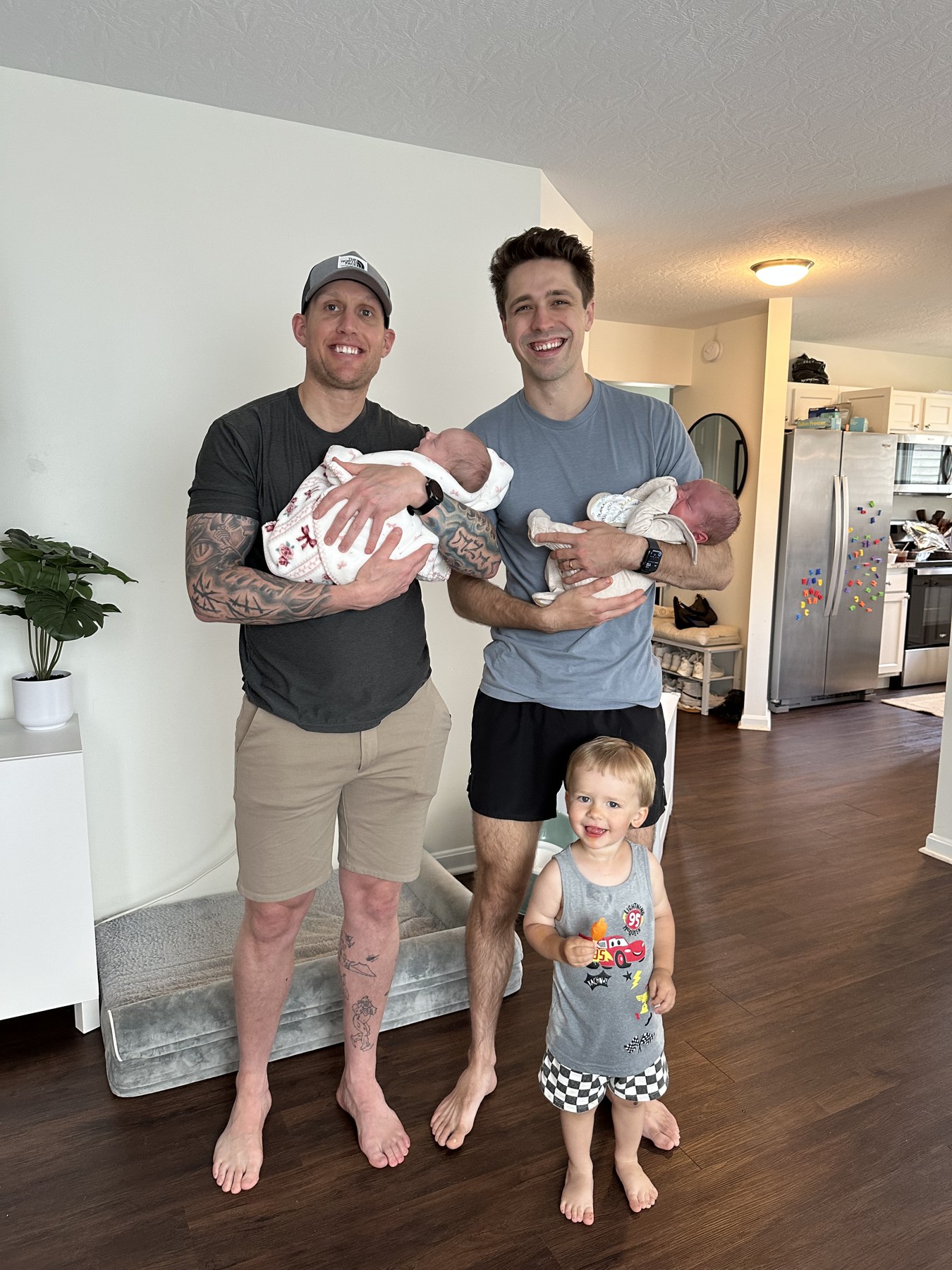 The two brothers behind NKY Junk Dads holding their newborns at home